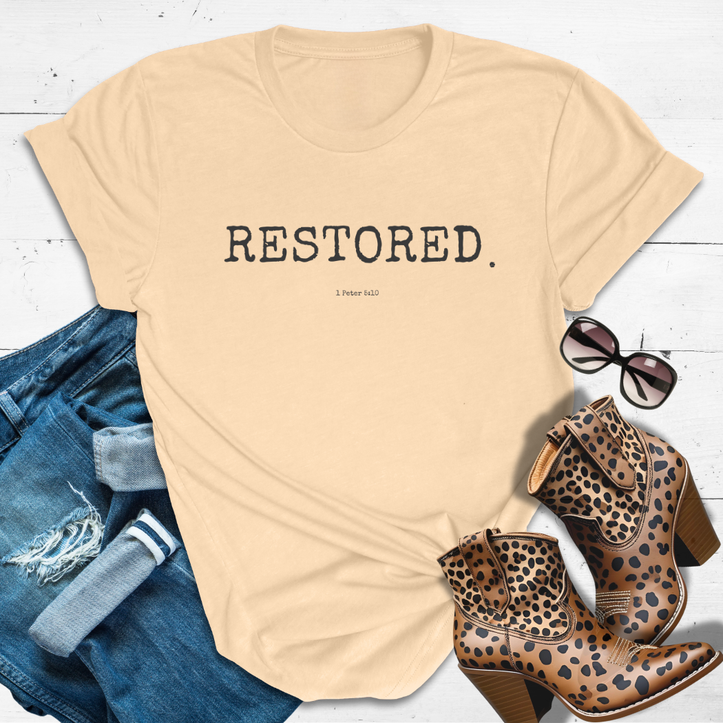 RESTORED.™ Tee — Healed. Whole. Held together by grace.