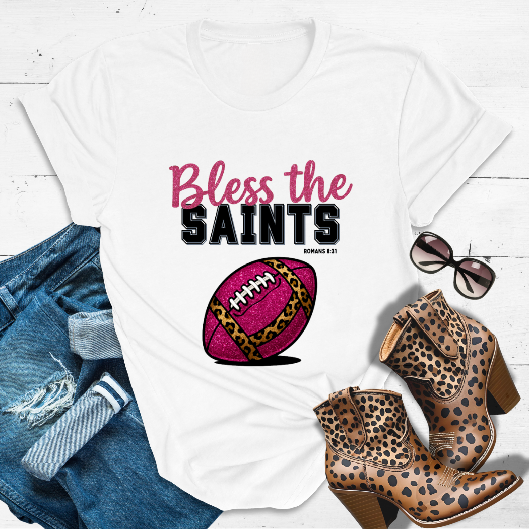 BLESS THE SAINTS™ Tee — Heaven’s got favorites — and she’s loud in the stands.