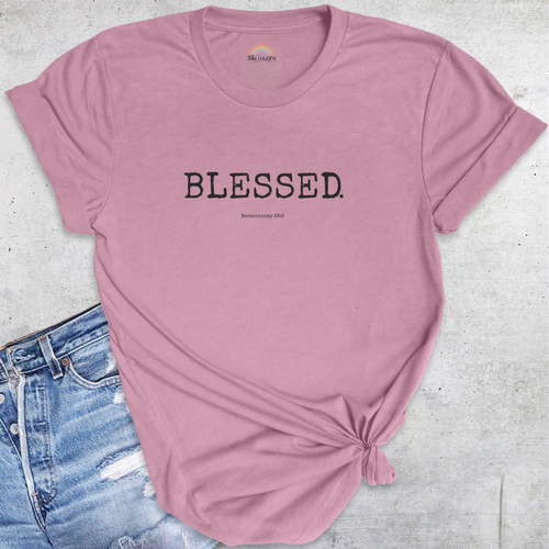Flatlay of mauve pink BLESSED.™ Christian t-shirt with black text — stylish women’s faith tee declaring covenant favor and grace